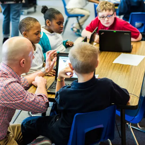 Teacher engaging with STEM elementary students